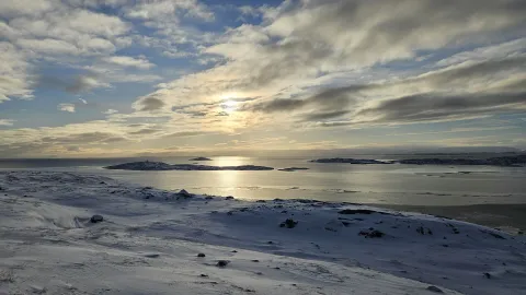 Cloudy sunset over a snowy landscape