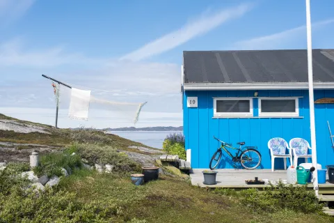 Blue house with a green bike on the deck